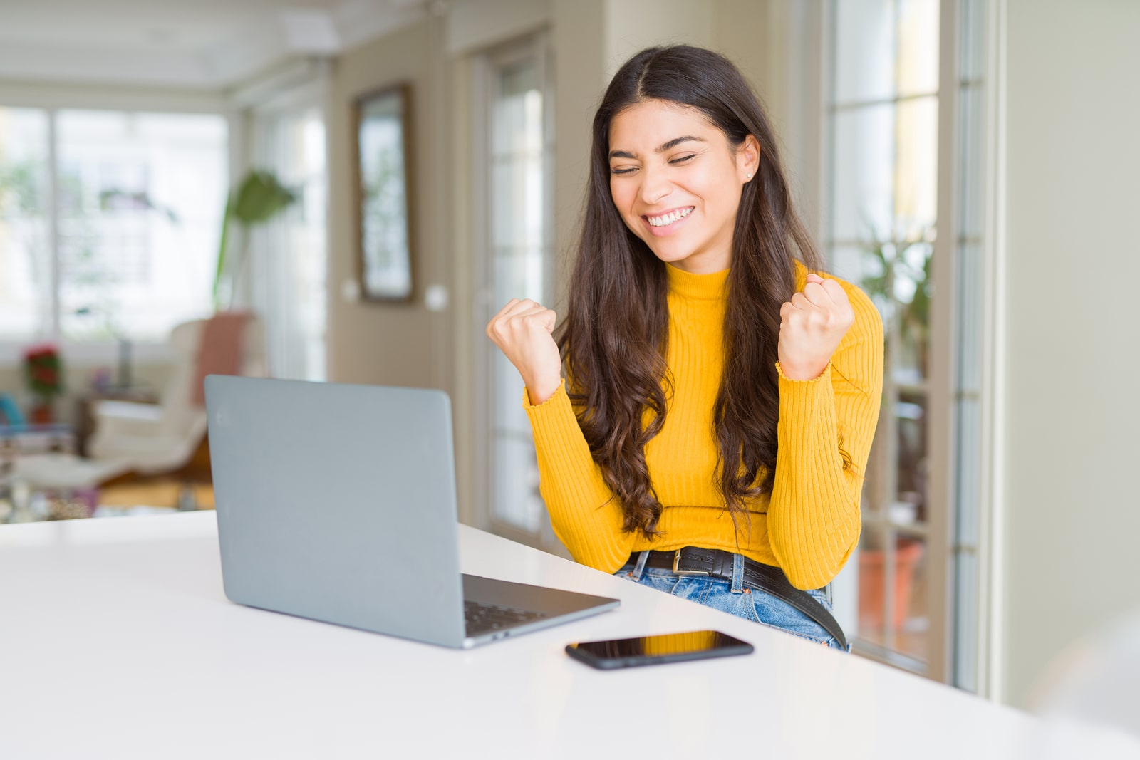 A young women celebrating after signing up for a no fee checking account