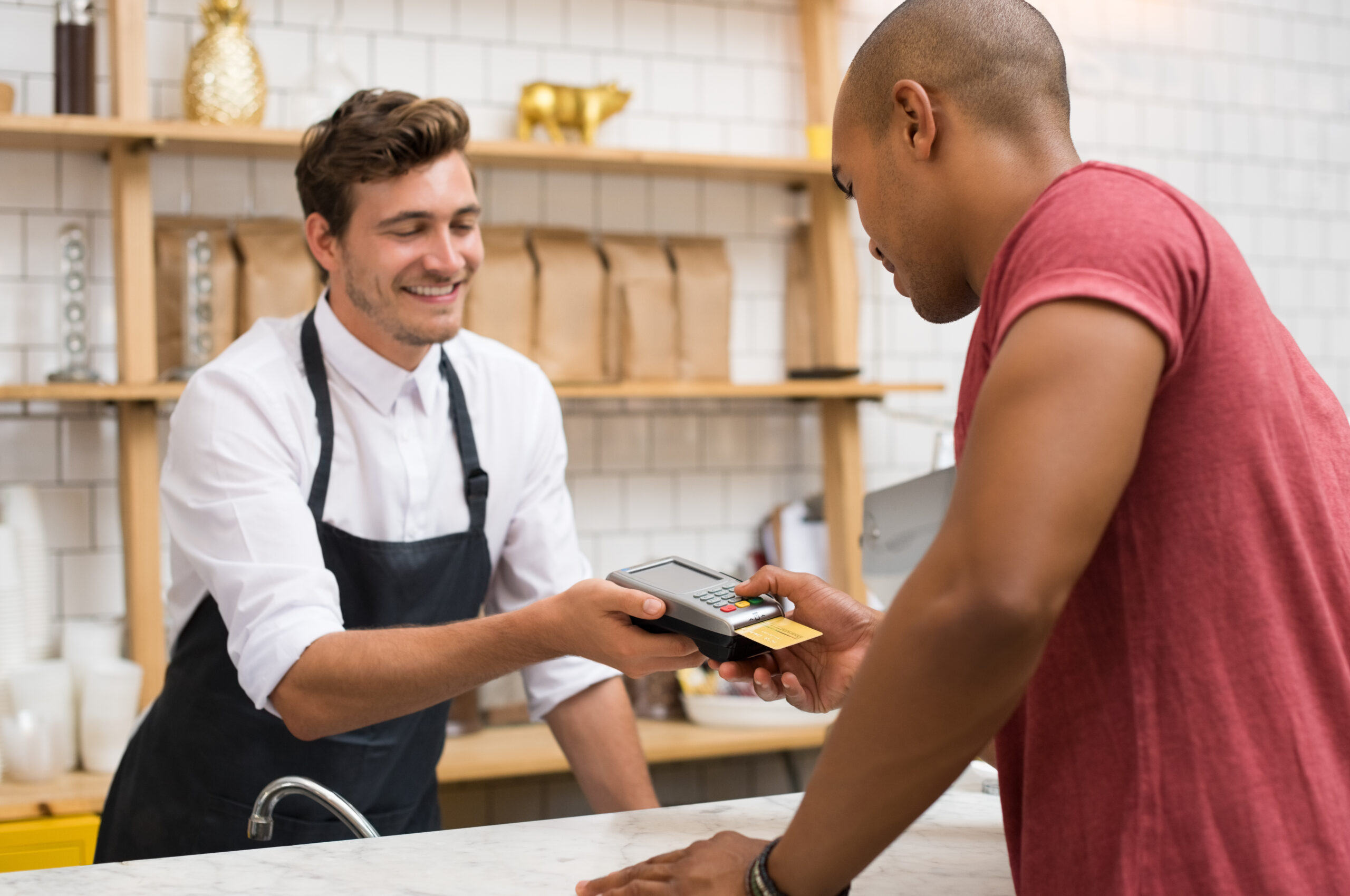 A man pays for his purchase with a credit union debit card.